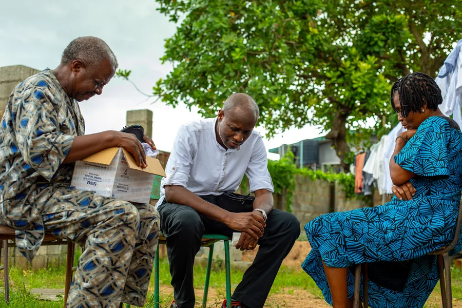 Ayobami listening closely with constituents